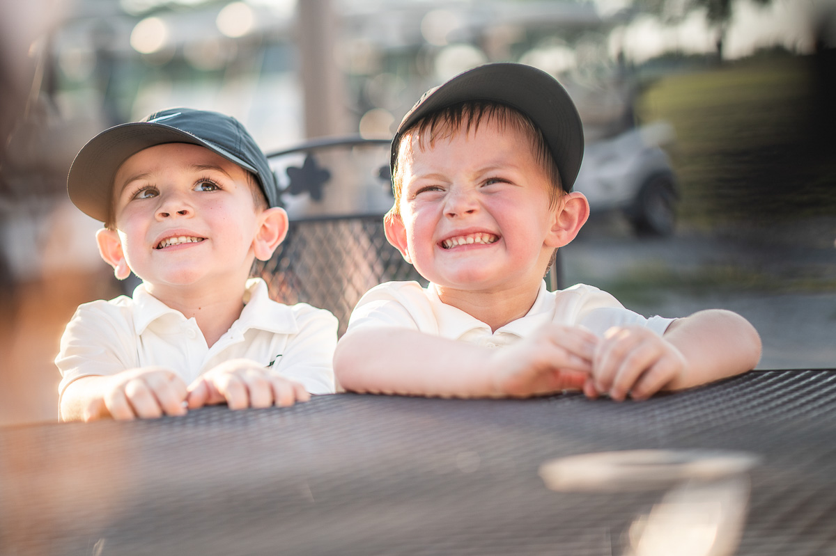 Natural family portrait in Kansas City, candid moment of siblings smiling